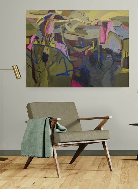 Green abstract oil painting with pink highlights on white wall above a chair with a green blanket in a room setting