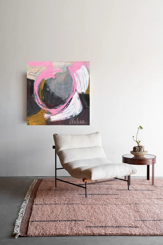 Pink, gray and gold abstract oil painting on stretched canvas created by artist danielle nelisse installed on white wall behind white modern chair and pink rug