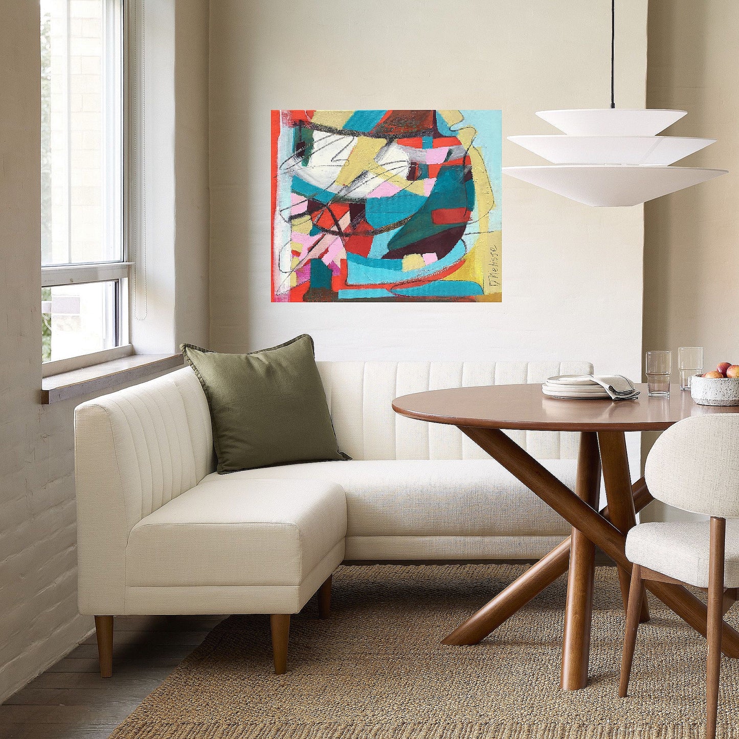 Red, aqua and yellow abstract painting on canvas created by artist danielle nelisse installed on white wall in modern luxury breakfast nook above designer white sofa in front of brown wood table and upholstered white chair